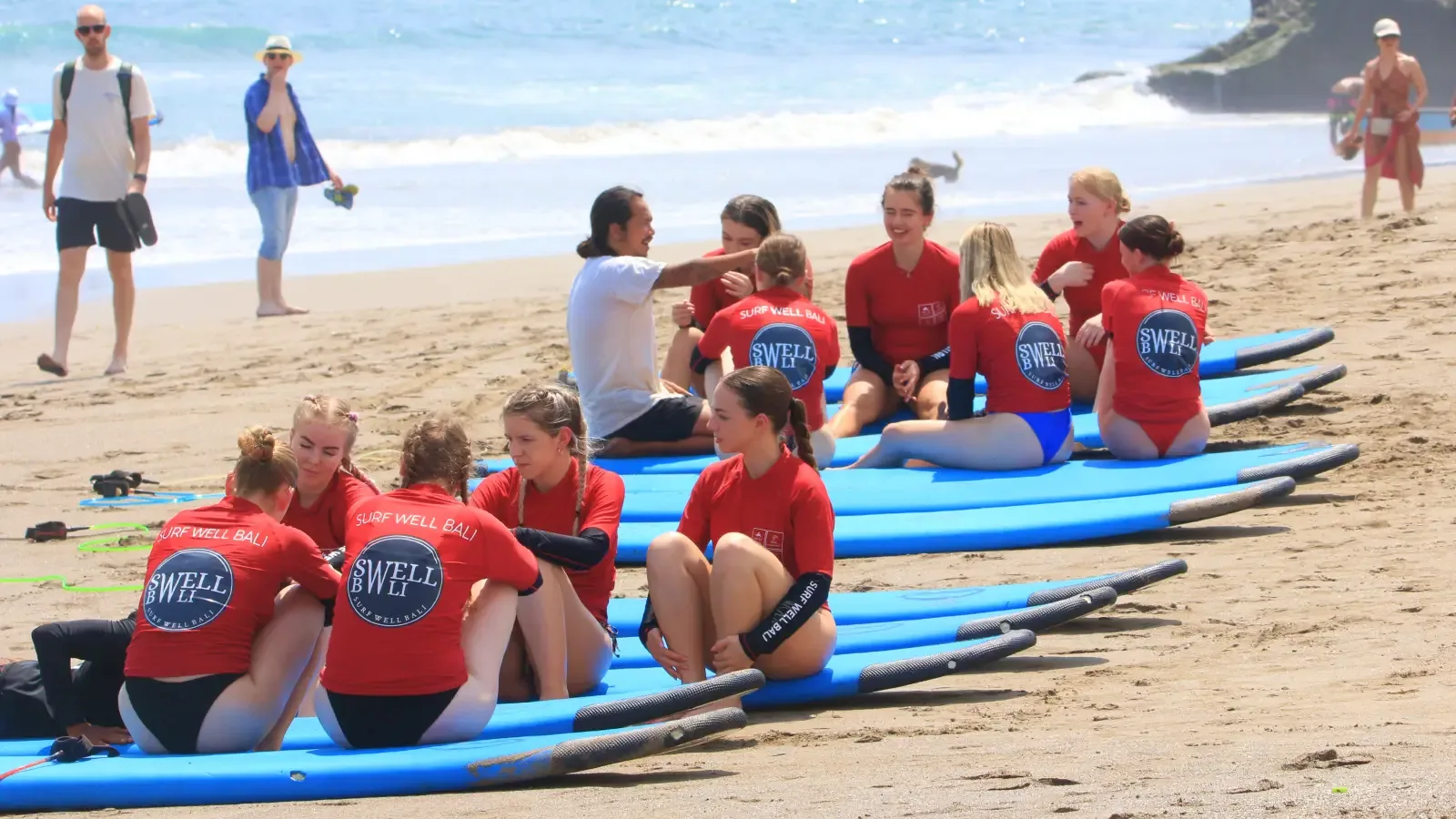 Surfwell Surf School instructor giving a surfing lesson at Canggu Beach